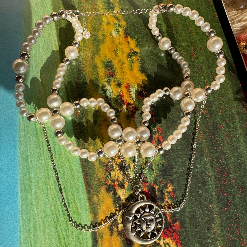 White pearl choker with silver chains and silver sun & moon pendant necklace